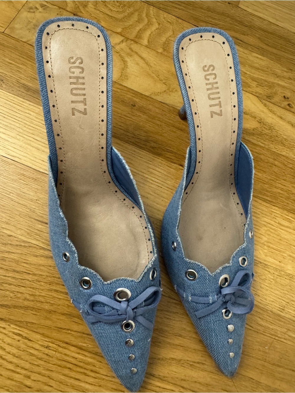 SCHUTZ Denim Pointed-Toe Slip-On Mules with Grommet & Bow Accents